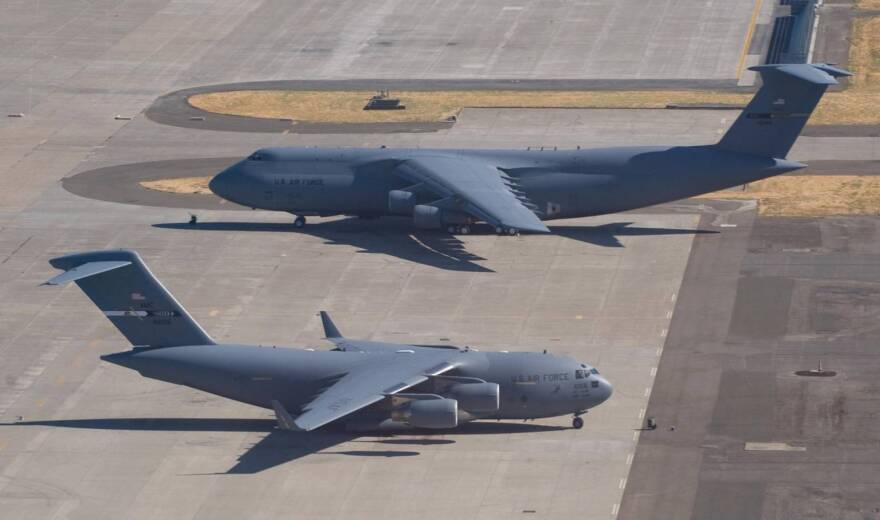 A U.S. Air Force C-5 Galaxy and a C-17 Globemaster sit on the tarmac at Travis Air Force Base in Fairfield, California, on July 17, 2008.