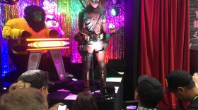 San Diego Comic-Con attendees watch a short music show at the Deadpool 2 booth during Preview Night, July 18, 2018. 