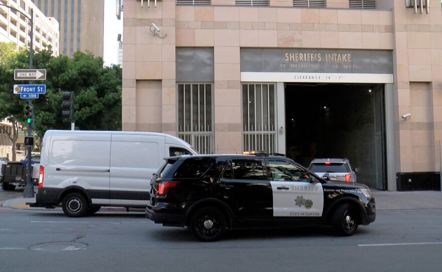 Law enforcement vehicles are shown entering the inmate intake gate at the Central Jail in downtown San Diego on April 26, 2022.