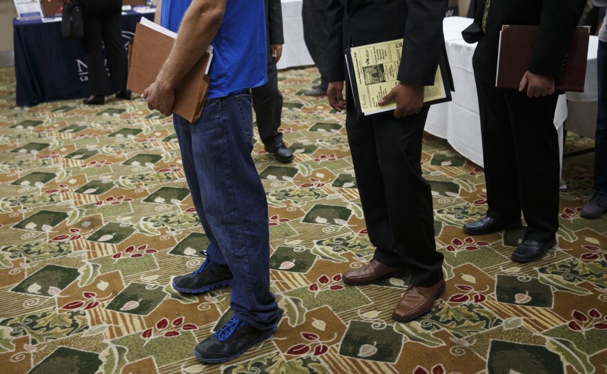 Job seekers wait to speak with representatives during a Choice Career Fair this summer in Los Angeles.