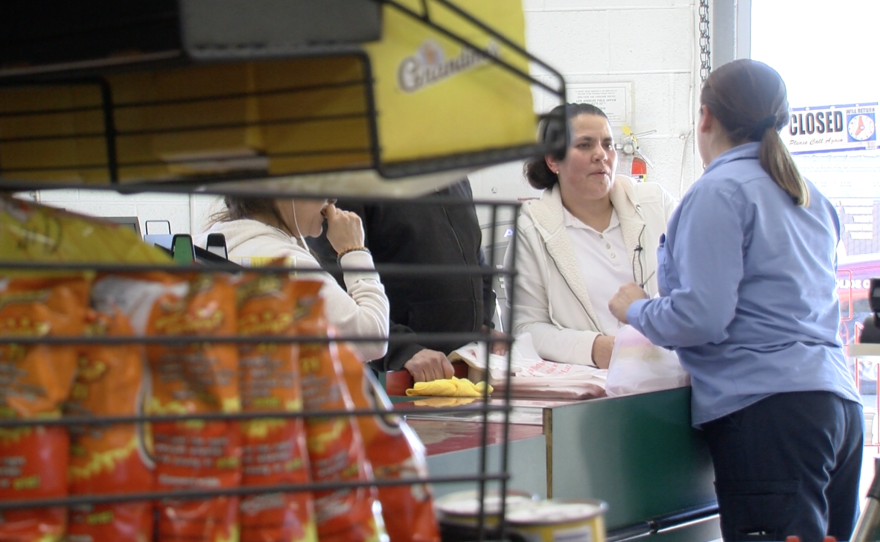 Teresa Gomez works at the cash register at a Barrio Logan grocery store, Jan. 20, 2017.