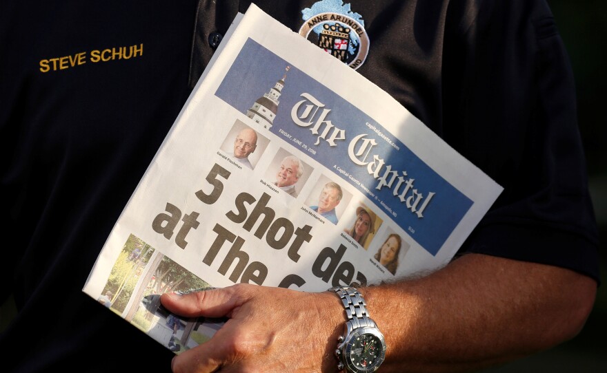 Steve Schuh, county executive of Anne Arundel County, Md., holds a copy of Friday's The Capital.
