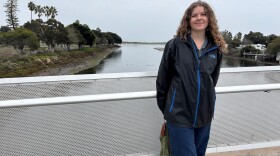 Savannah Stallings, with the San Diego Bird Alliance, stands on a bridge spanning Rose Creek as it flows into Mission Bay in San Diego. Dec. 31, 2025
