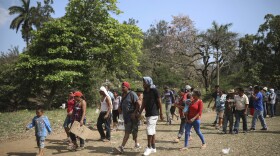 Central American migrants arrive to a sports center during the annual Migrant Stations of the Cross caravan or "Via crucis," organized by the "Pueblo Sin Fronteras" activist group, in Matias Romero, Oaxaca state, Mexico, Monday, April 2, 2018. 