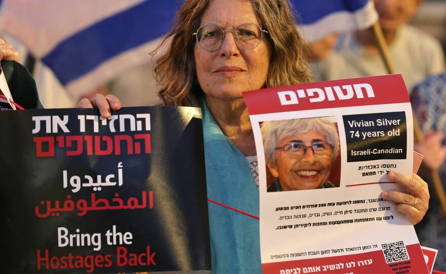 A demonstrator holds a poster showing Israeli Canadian Vivian Silver, who was missing and was presumed to be held by Palestinian militants since Hamas' Oct. 7 attack, during a protest for her release outside the president's residence in Jerusalem on Oct. 29.