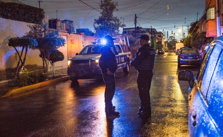 Alejandro García (left) and Agustin Ricardo Anaya, members of the local police force, investigate a stolen vehicle in the state of Mexico, part of the greater metropolitan area of Mexico City, in August 2017.