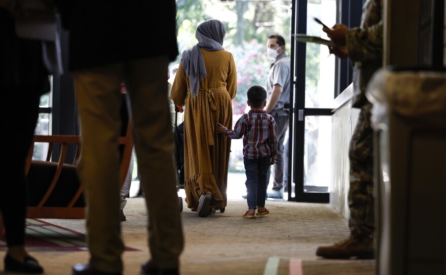 An Afghan woman and her son walk through the National Conference Center, redesigned to temporarily house Afghan nationals, on Aug. 11 in Leesburg, Virginia. Operation Allies Welcome recently turned the NCC into a hotel-like location where Afghan nationals who recently left Afghanistan can begin the process of resettling in the United States.