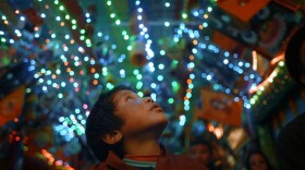 Peyangki looks at the lights of the city.