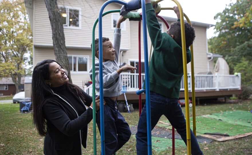 Mercedes and her two sons Lucas, 7, (center) and Sebastian, 5, (right) play in their backyard. Mercedes' husband is a guard at New York's Rikers Island jail. Her sons struggled with home schooling, so in late August, with some trepidation, she gave up her corporate job.