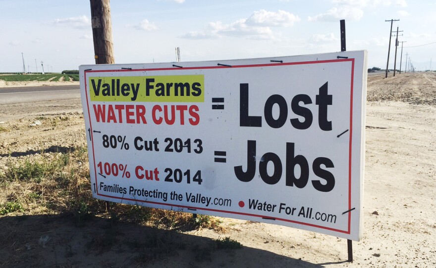 Within the boundaries of the Westlands Water District, handmade signs near fallowed fields protest federal water policy.