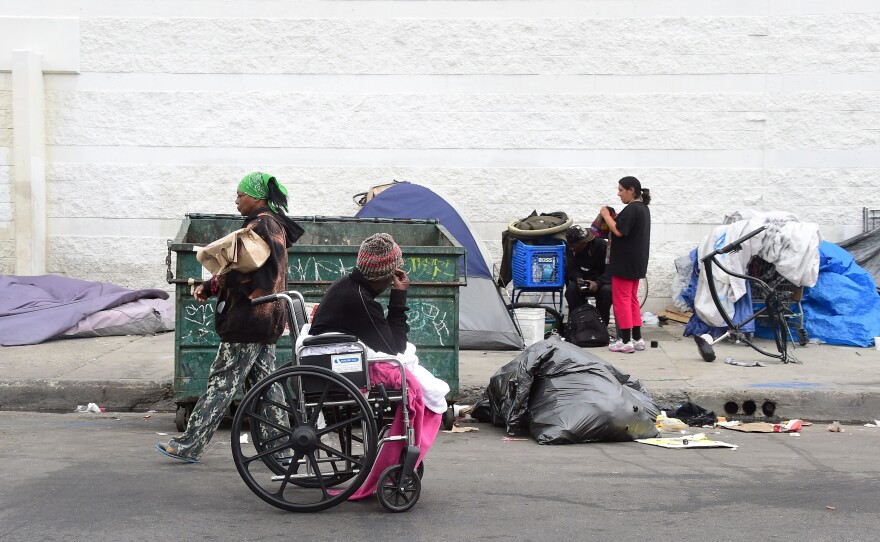 Homeless women prepare for a night spent on a street near Skid Row in Los Angeles, in May. Not every case of homelessness is so easy to spot as this, though; some groups say the Department of Housing and Urban Development numbers missed many people without stable housing.