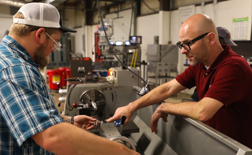 Moss (left) spends two days a week in Matt Walrond's Machining II class at Pulaski Technical College in North Little Rock.