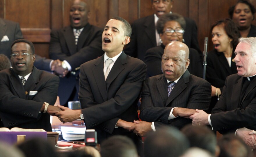 Then-Senator Barack Obama, Rep. John Lewis, D-Georgia, and Rev. Clete Kiley hold hands and sing at the end of a church service in Selma, Ala., on the 2007 commemoration of "Bloody Sunday."