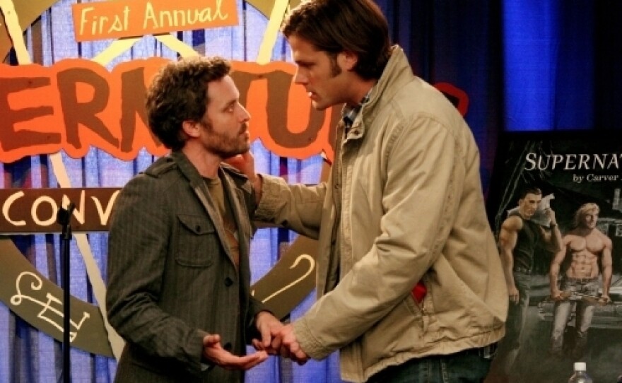 Jared Padalecki plays Sam Winchester (right), one of the stars of the series <em>Supernatural. </em>The Winchester brothers also star in the series-within-the-series, which is -- meta alert! -- also called <em>Supernatural. </em>Here, Sam talks to the (fictional) series author at a (fictional) convention for (fictional) rabid fans.
