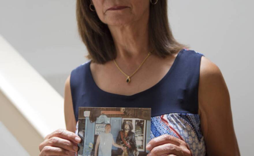 This undated photo shows Lydia Nunez holding a photo of her son, Ruben.