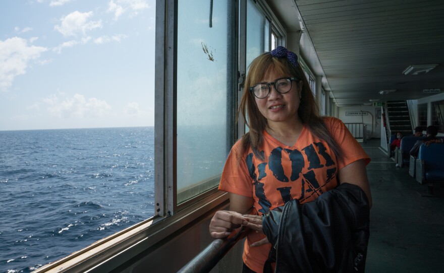 Juraidah, 27, works in Taiwan to support her family and hasn't been home in three years. Her father died while she was gone and she is returning for two weeks to visit her mother and other family members.