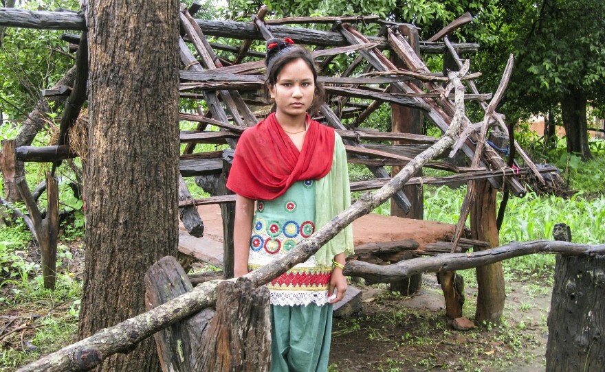 Kamala stands in front of the hut where she sleeps when she has her period. She lives in western Nepal and was 14 when the photo was taken for an NPR story. She told us: "I'm afraid of snakes and men."