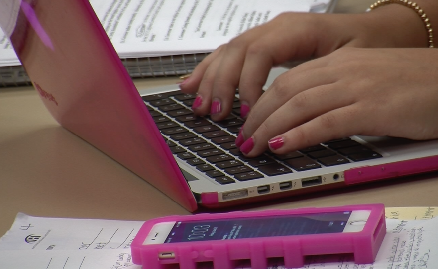 Lucia Regina Reyes Gonzalez, 16, types at her MacBook at the California Lorenzo de Zavala Youth Legislative Session, June 26, 2015. 