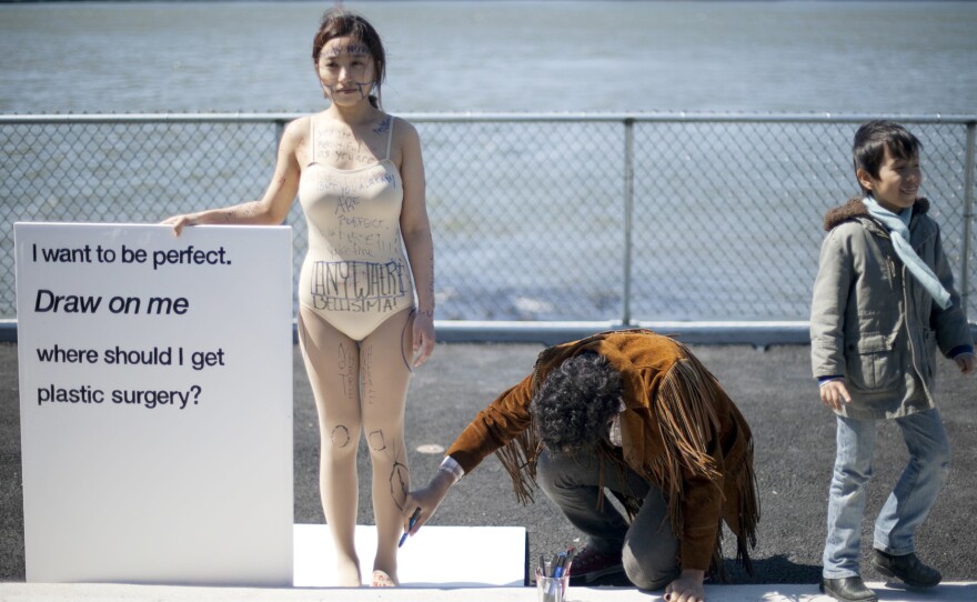 For her project "Draw on Me," photographer Ji Yeo asked strangers to mark the parts of her body they thought she could change.