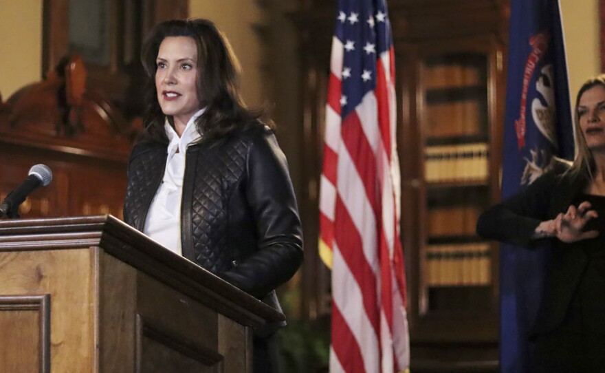 Michigan Gov. Gretchen Whitmer addresses the state during a speech in Lansing, Mich., on Thursday. Thirteen members of two militia groups face criminal charges after allegedly plotting to kidnap Whitmer.