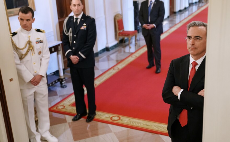 Cipollone watches a White House event from the sidelines.
