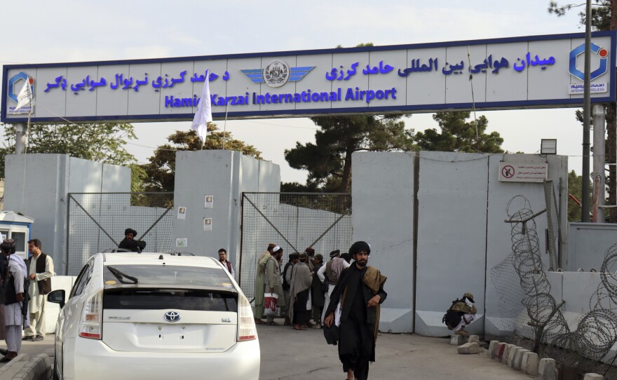 Taliban fighters stand guard in front of the Hamid Karzai International Airport after the U.S. withdrawal in Kabul, Afghanistan.