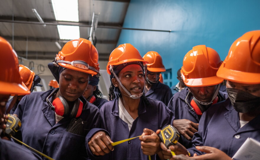 Students take part in a tiling class at the Buildher training facility in Nairobi, Kenya.