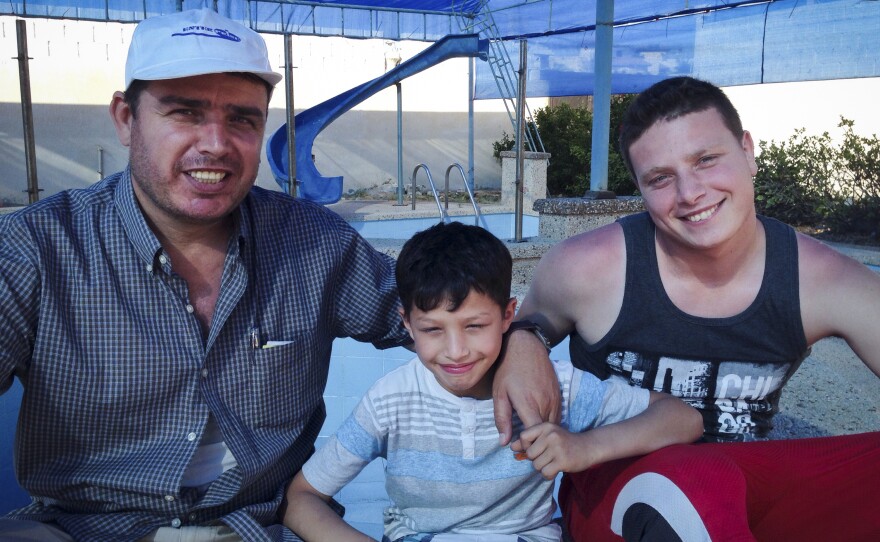 Ihab al-Aloul (left) and his sons Abdel Rahman, 9, and Ahmed, 22, at the family's pool in Gaza City. The al-Aloul family left Gaza in 2008 and moved to Vancouver, but returned to Gaza in the fall of 2014.