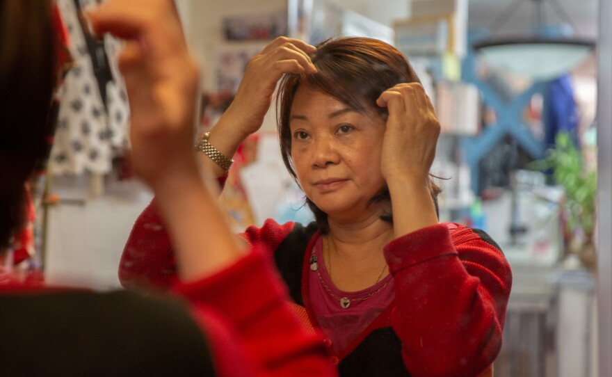 Lai adjusts her hair during breaks.