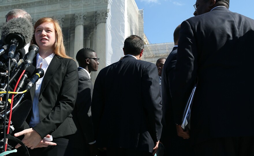 Abigail Noel Fisher, who challenged a racial component to University of Texas at Austin's admissions policy, speaks to the media outside the U.S. Supreme Court building during arguments in the case in October of 2013.