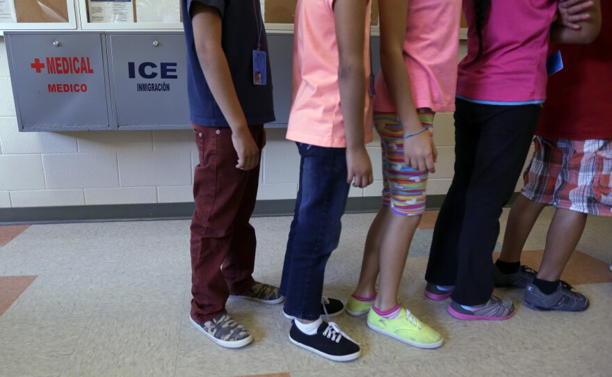Detained immigrant children line up in the cafeteria at the Karnes County Residential Center, a temporary home for immigrant women and children detained at the border.