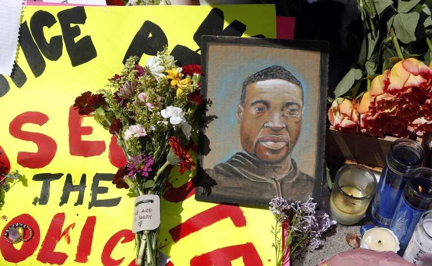 A portrait of George Floyd is part of the memorial for him near the site of his arrest. He died Monday night in Minneapolis; video shared online by a bystander showed a white officer kneeling on his neck during his arrest as he pleaded that he couldn't breathe.