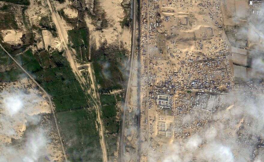 This Feb. 18 satellite photo shows displaced Palestinians crammed into southern Gaza on the right. Israel is threatening to attack the border town of Rafah, where more than 1 million Palestinians are now living. On the left is the vast, empty expanse of Egypt's Sinai Peninsula. Egypt says it won't allow Palestinians into Egypt because it fears they might not be allowed back into Gaza.