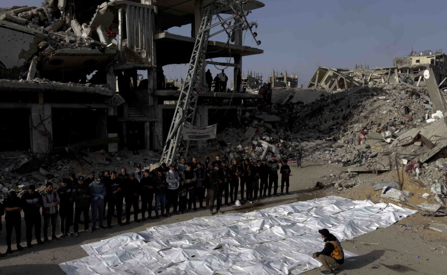 At the end of a three-day search mission, family members, neighbors, and civil defense staff perform funeral prayers over the bodies of 50 members of the Abu Naser family recovered from beneath the rubble of their home destroyed in an Israeli strike in October 2024