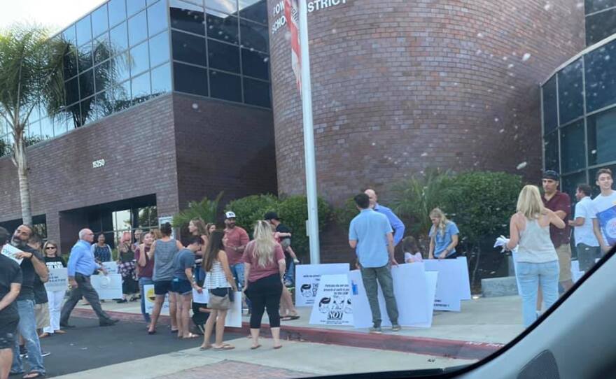 Protestors rally outside the Poway Unified School District offices before a board meeting. September 9, 2021.