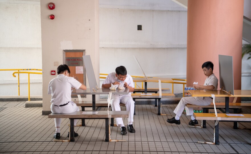 For snack time, tables are socially distanced — and some have dividers.