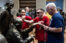 The National Constitution Center in Philadelphia offers guided tactile tours aimed at blind and low vision visitors in a gallery called Signers' Hall. Museum educator Sydney Wharton traces visitor Tim Kelly's Jr. hands over the statue of Benjamin Franklin as she leads him and his father, Tim Kelly Sr., through the gallery.