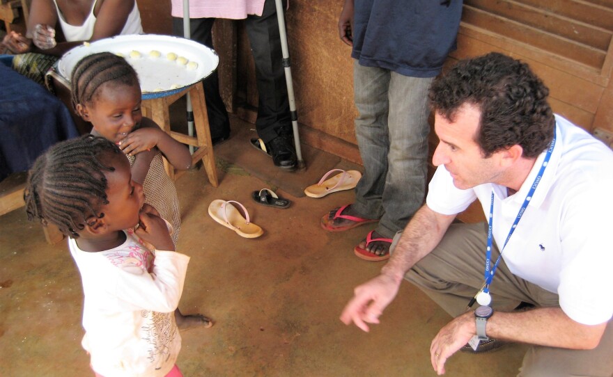 Dr. Paul Spiegel greets children displaced by conflict in Ivory Coast while undertaking an assessment mission in 2017.
