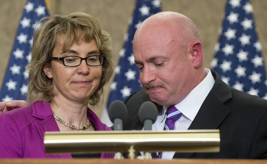 Former Arizona Rep. Gabrielle Giffords and her husband, Mark Kelly, at an April 16 ceremony naming a Capitol Hill conference room for her aide Gabe Zimmerman. Zimmerman died in the same Tucson, Ariz., shootings that Giffords wounded.
