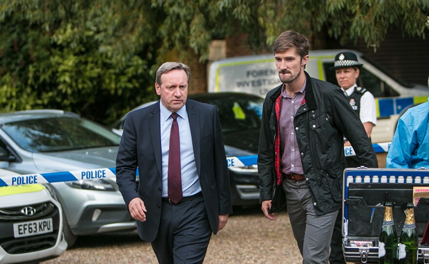 Detective Chief Inspector John Barnaby (Neil Dudgeon) and Detective Sergeant Charlie Nelson (Gwilym Lee) in a scene from MIDSOMER MURDERS "A Vintage Murder."