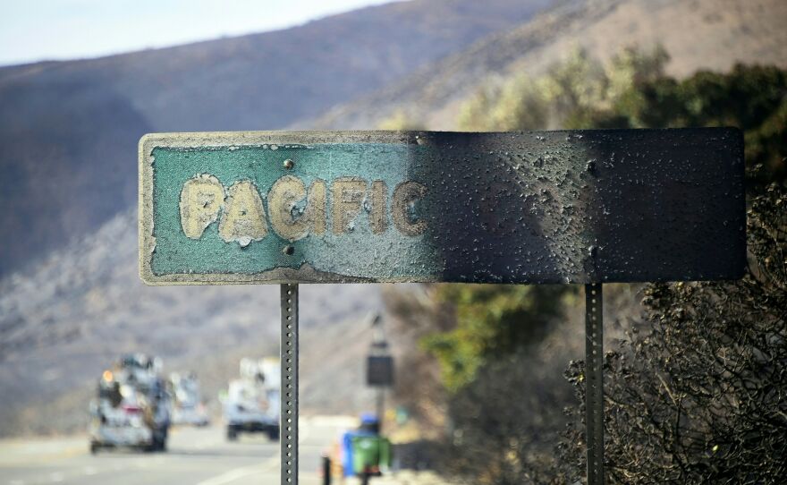 A Pacific Coast Highway sign stands scorched by the side of the road in Malibu, Calif. The Woolsey Fire ravaged some of the area's most iconic landmarks, including a Paramount Ranch left in ruins.