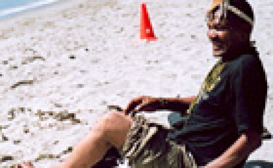 Sesana slips off his shoes on the beach at Paradise Cove in Malibu -- a long way from his home in the Kalahari Desert.