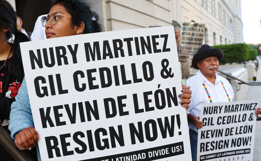 Protesters outside City Hall call for the resignations of LA City Council members Kevin de Leon and Gil Cedillo on Wednesday.