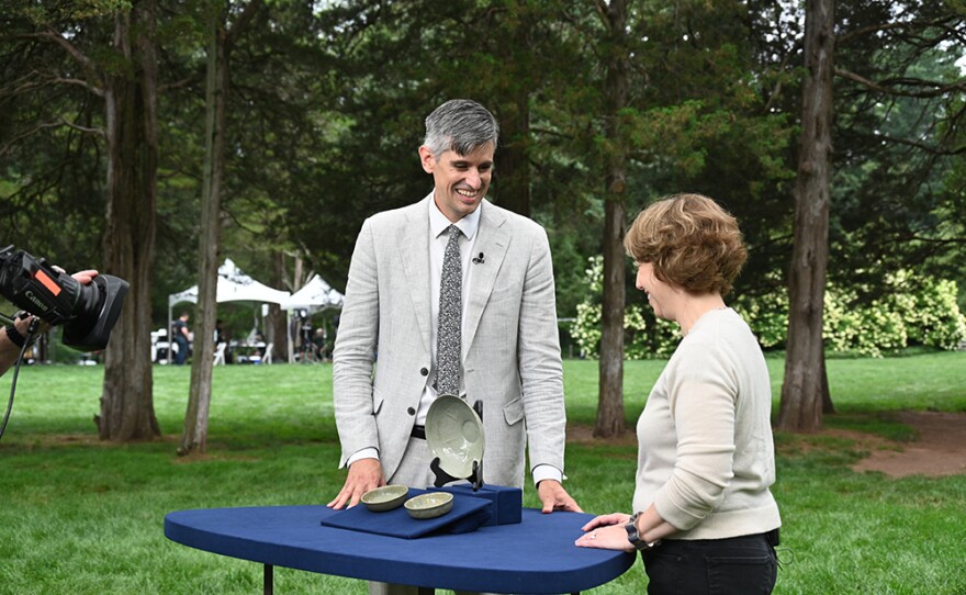 Richard Cervantes (left) appraises 12th and 13th C. Korean Celadon bowls, in Middletown, Conn.
