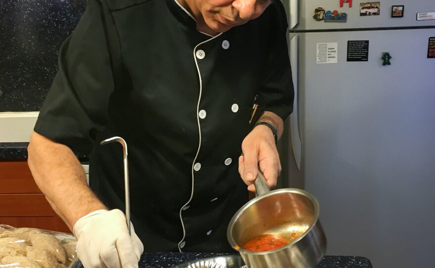 Gaza cuisine is all about pepper, says chef Jamal Sobeh as he ladles pepper sauce over fried sardines in the kitchen of the U.S. Consulate in Jerusalem. Sobeh prepared a variety of Gaza-style dishes for a U.S. effort to promote agricultural business, including exports, from Gaza.