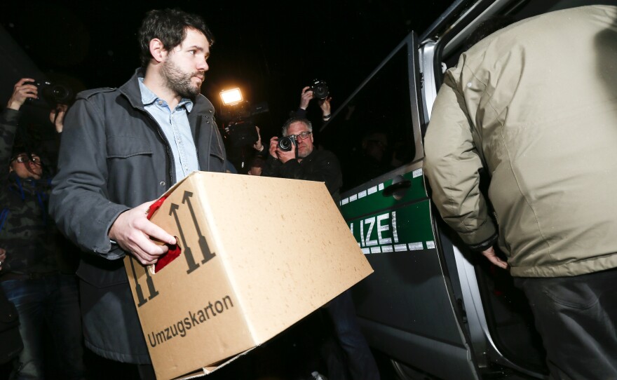 A German police investigator carries a box after searching an apartment believed to belong to the crashed Germanwings flight 4U 9524 co-pilot Andreas Lubitz in Duesseldorf, on Thursday.