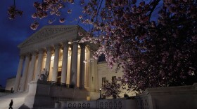 A security officer walks along the west front of the U.S. Supreme Court Building on March 28, 2012 in Washington, DC.