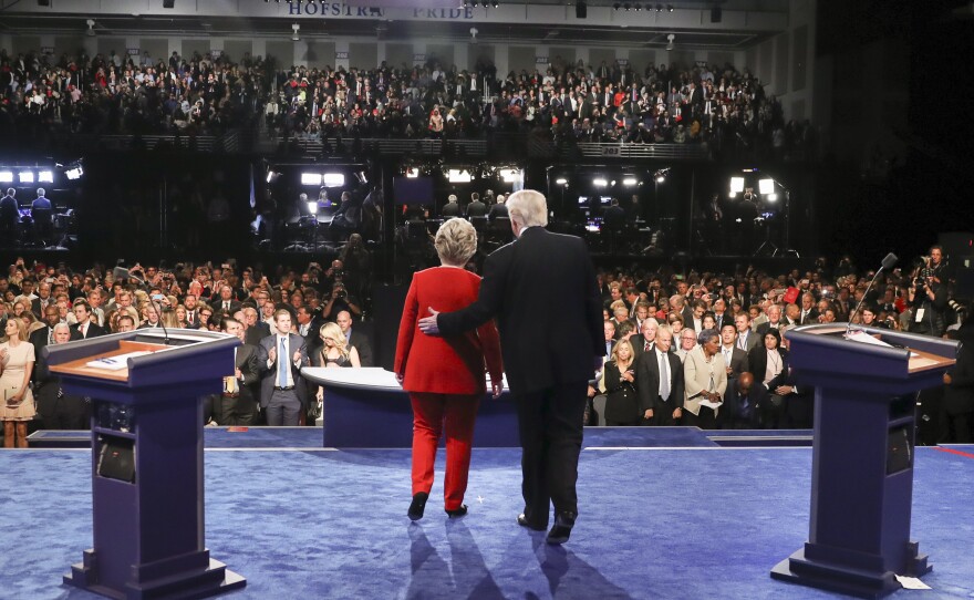 Presidential candidates Hillary Clinton and Donald Trump acknowledge their debate audience Monday night at Hofstra University. Tens of millions more were watching in audiences gathered elsewhere.