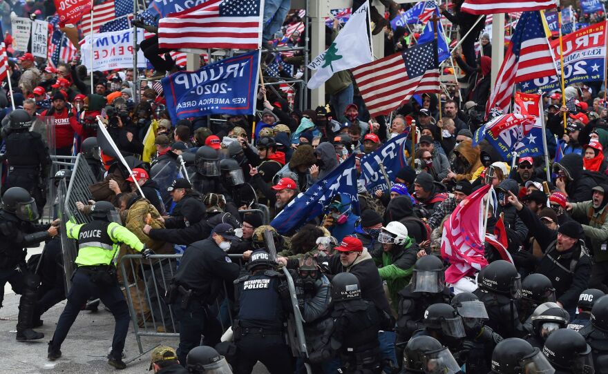 Rioters clash with police as they push barricades to storm the U.S. Capitol on Jan. 6, 2021.