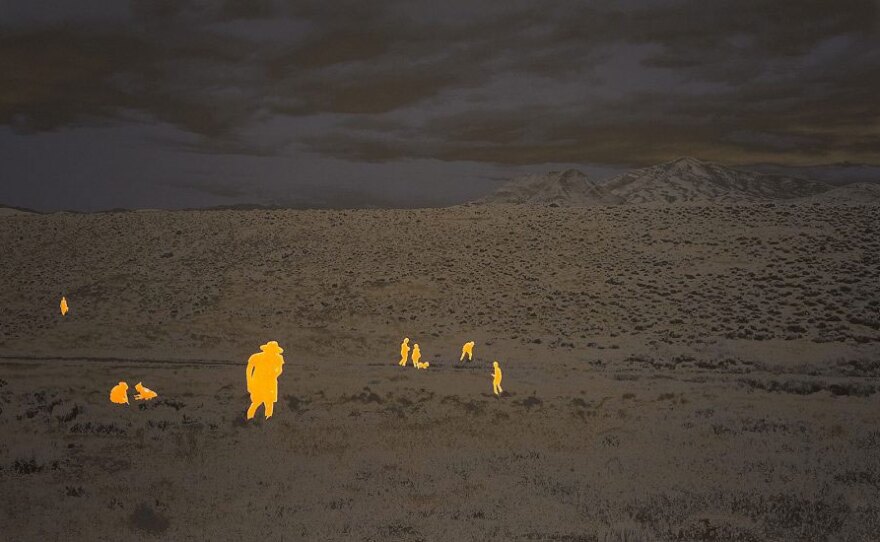 "A Group of Artists and Academics at the OXCART Crash Site, near Wendover, Utah, August 2012 (raw umber and deep grey-blue with orange glow-in-the-dark glitter blisters)," by John Brinton Hogan will be on view at San Diego Art Institute as part of the SD Practice exhibition, opening July 10, 2021.